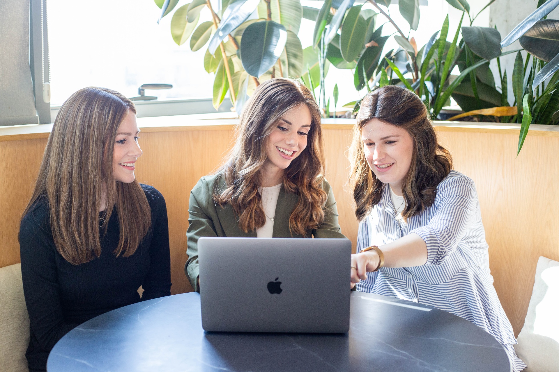 The Michal Eisik Media team gathered around a laptop, building a website together